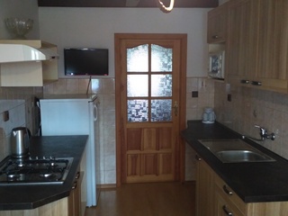 Kitchen with TV, fridge, microwave and cooker
